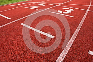 Start. Red running racetrack on the outdoor athletic stadium