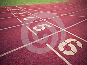 Start. Red running racetrack on the outdoor athletic stadium