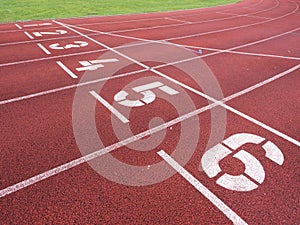 Start. Red running racetrack on the outdoor athletic stadium