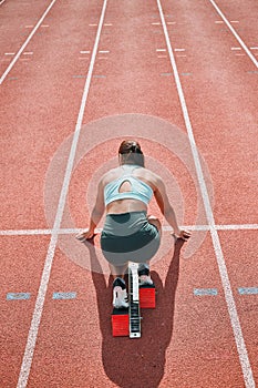 Start, running and fast with woman on race track for sports, competition and marathon. Exercise, health and wellness