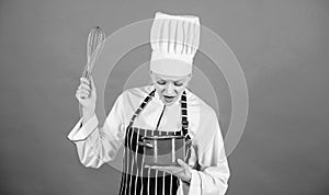 Start slowly whisking whipping or beating cream. Whipping cream tips and tricks. Use hand whisk. Woman professional chef photo