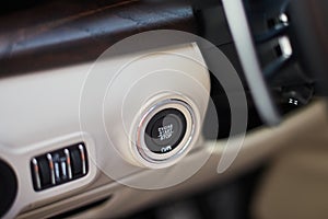 A Start-stop button to start the engine in a luxury car.