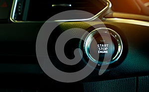 Start stop engine button of luxury car. Push up button for start or stop car engine in keyless automobile. Turn key with ignition