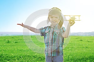 Start traveling from childhood even in imagination. Young Boy playing to be airplane pilot, funny guy with aviator cap