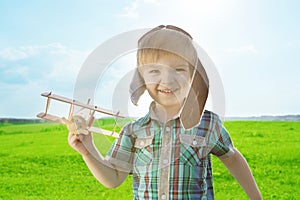 Start traveling from childhood even in imagination. Young Boy playing to be airplane pilot, funny guy with aviator cap