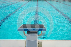 Start up block with lane of water in blue swimming pool