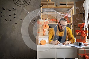 Start up small business entrepreneur SME freelance man working with box for Halloween, young small business owner office