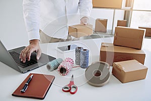 Start up small business owner entrepreneur SME, using laptop for online business in office room