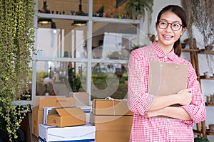 Start up small business owner holding clipboard at workplace. fr