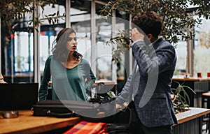 Start-up team in a lively discussion at a modern urban coffee shop