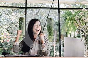 Start up woman raise fist with yes gesture at office. freelance