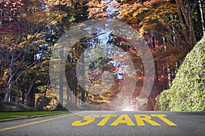 Start word on road surface with autumn season background