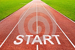 Start written on starting line on of running track of sports field