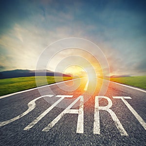 Start written to the ground on a road at sunset. Concept of new beginning and starting new opportunities