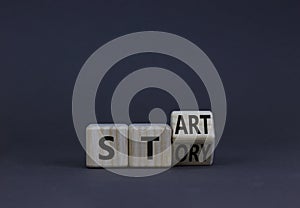 Start your story symbol. Turned the wooden cube and changed the concept word Start to Story. Beautiful grey table grey background