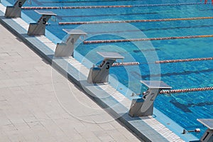 starting blocks at competitive swimming pool lanes