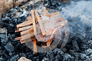 Starting the camp fire with kindling. Camping life