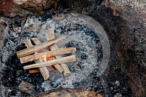Starting the camp fire with kindling. Camping life
