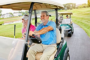 Starting the day with some golf. people on a golf course.