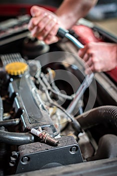 Starting ignition plug Car mechanic in auto repair