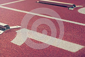 Starting line. Red running track with lane numbers. Sport Background.