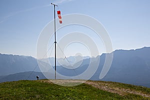 Starting point near Garmisch Partenkirchen of paragliders with red and white windsocks. In the background mountain peaks in the Ge