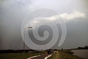 Starting shelf cloud above the along river Hollandse IJssel in Moordrecht in the Netherlands