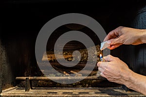 Starting up a fire inside a chimney with lighter cubes