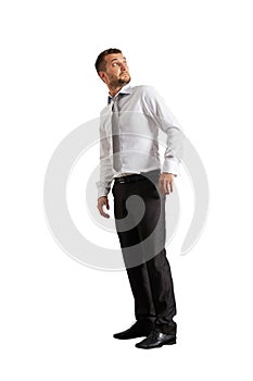 Startled businessman looking up