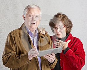 Startled Couple with Tablet