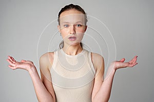 Startled Woman With Surprised Expression on gray background