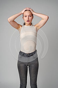 Startled Woman With Surprised Expression on gray background