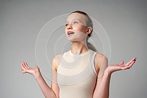 Startled Woman With Surprised Expression on gray background