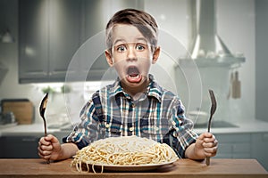 Startled yound boy with noodles photo