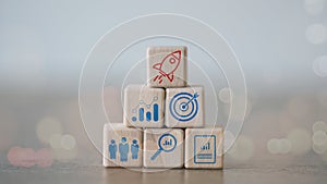 Startup business concept. wooden blocks with business start-up icons, Starting a business quickly with a rocket icon. Business