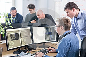 Startup business problem solving. Software developers working on desktop computer. photo