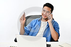 Startup business man smiling while talking on the phone and having fun at work