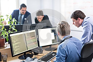 Startup business problem solving. Software developers working on desktop computer.