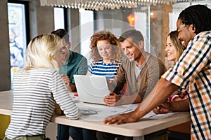 Startup business team on meeting in modern bright office interior and working together