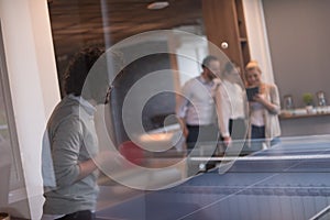 Startup business team playing ping pong tennis