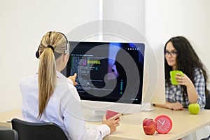 Startup business, young woman as software developer working on computer at modern office