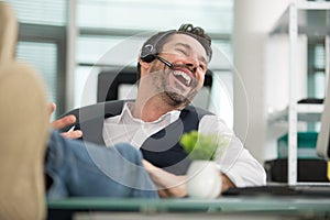 Startup businessman laughing while talking on phone