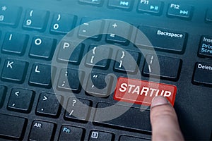 Startup button on black computer keyboard,startup background concept