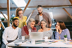 Startup concept. Designer team using laptop in office