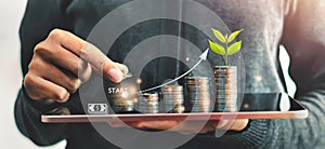 Startup concept with icon business and network connection with people putting coins stack  and plant growth on money