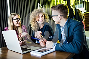 Startup diversity teamwork brainstorming meeting concept. People working planning start up. Group young man women looking over lap