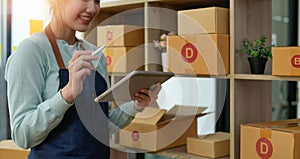 Startup small business entrepreneur SME, asian woman checking order. Portrait young Asian small business owner home