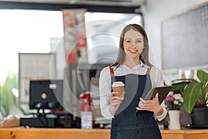 Startup successful small business owner sme beauty girl stand with tablet in coffee shop restaurant. Portrait of asian