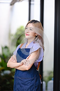 Startup successful small business owner sme beauty girl stand with tablet smartphone in coffee shop restaurant. Portrait