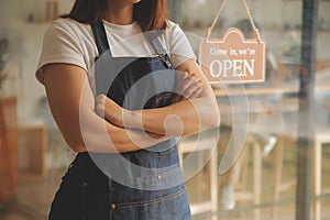 Startup successful small business owner sme beauty girl stand with tablet smartphone in coffee shop restaurant. Portrait of asian